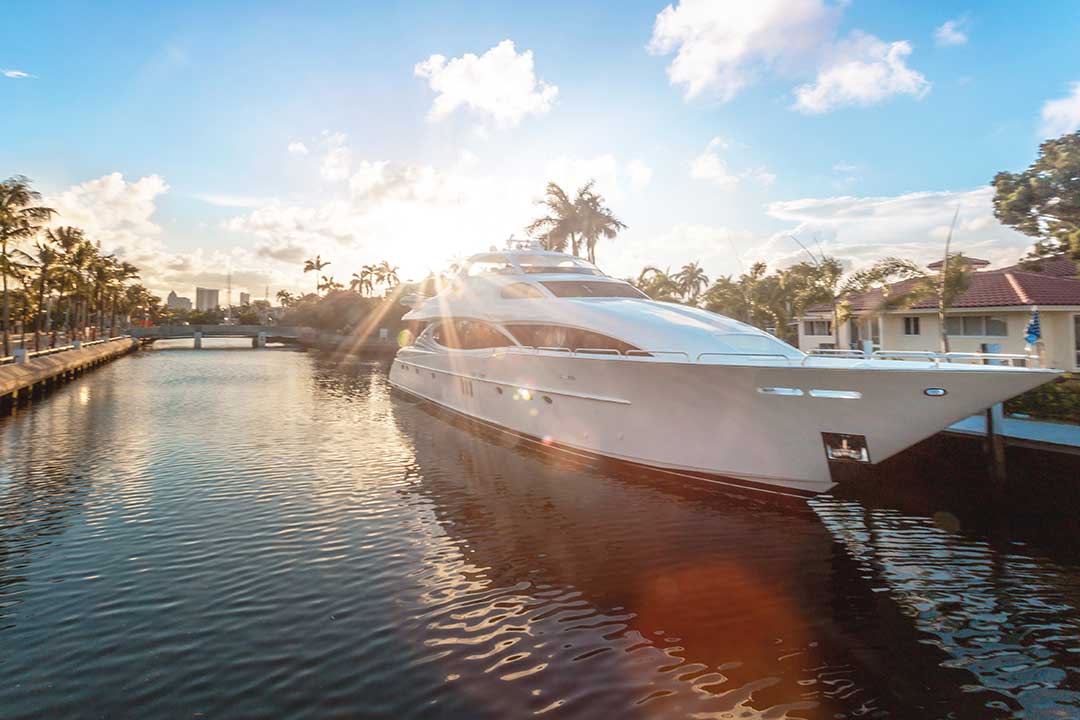 A large yaht style boat docked behind a house in Florida