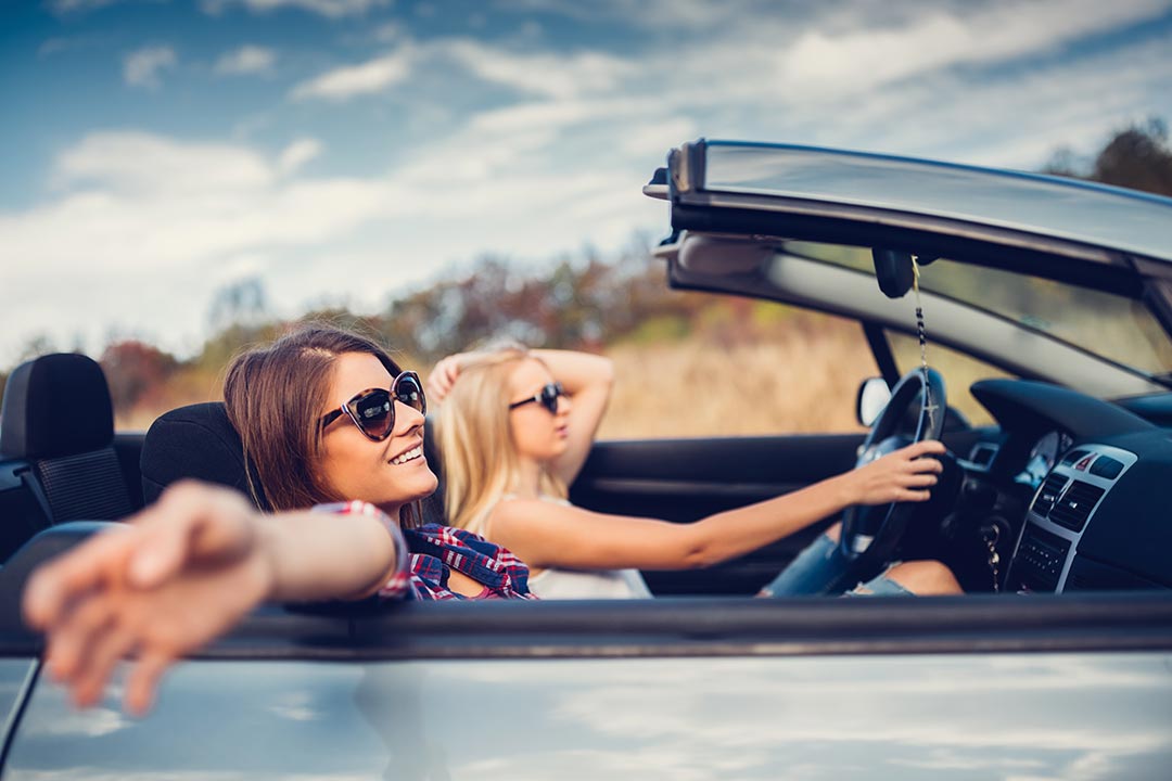 friends driving around in a convertible car